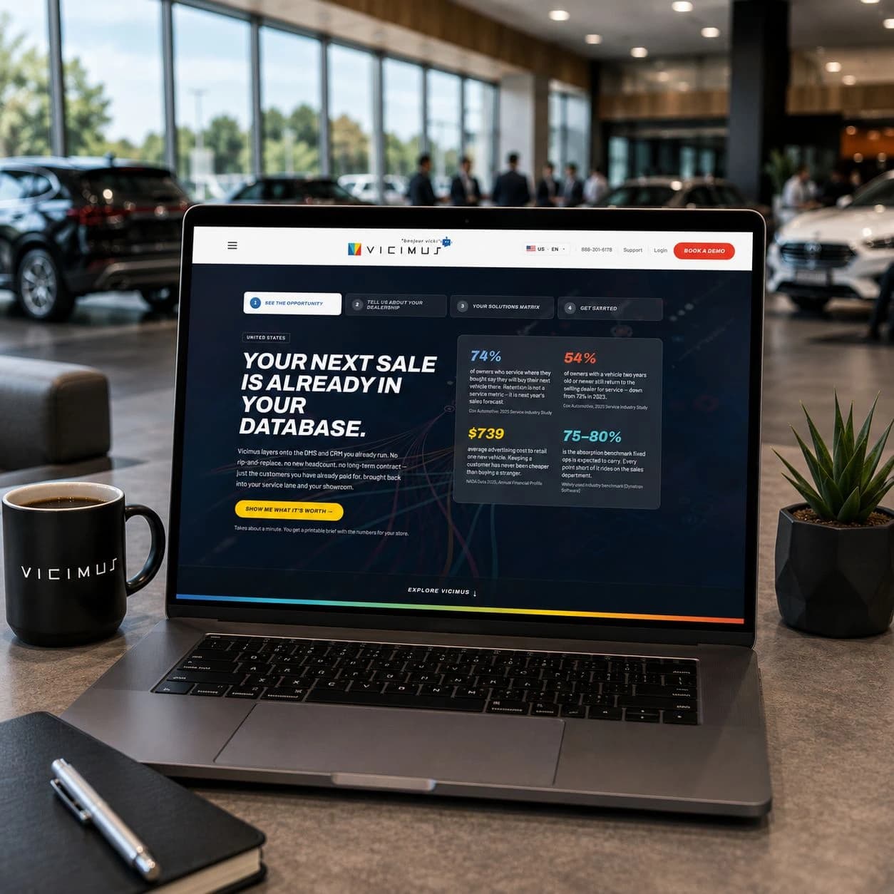 Vicimus website presented on a laptop in a dealership showroom